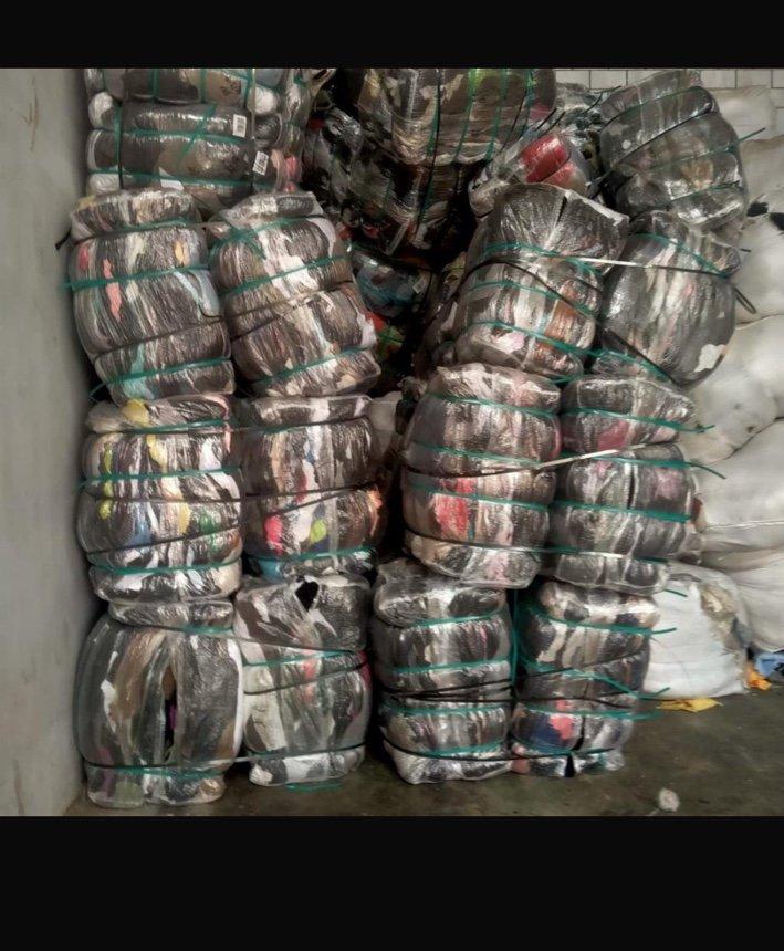 Bales of clothing in a warehouse